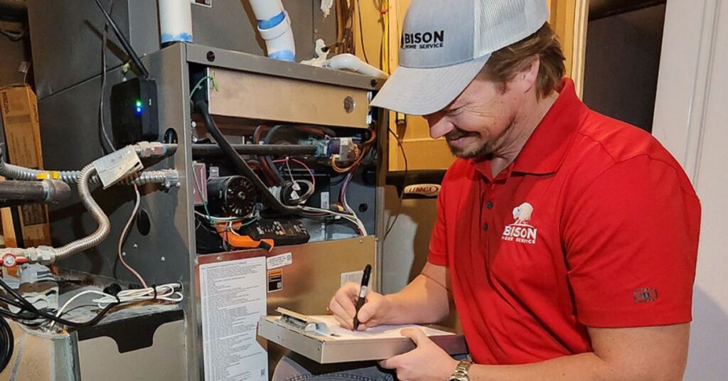 Furnace technician performing a furnace tune-up
