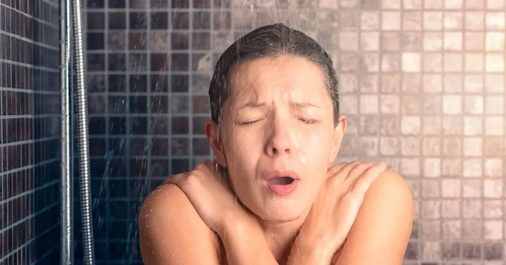 woman experiencing cold water in the shower